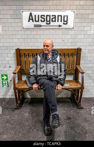 Métro Sophie-Charlotte-Platz U-Bahn de la station de métro sur la ligne de rail U2 à Berlin-Charlottenburg.Un homme âgé sur le banc d'attente pour former Banque D'Images