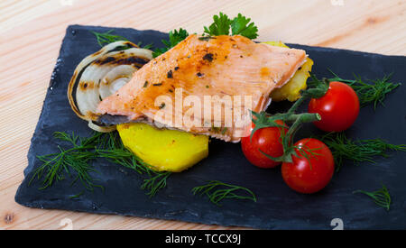 L'ardoise avec de tendres filets de truite, les pommes de terre, tomates cerises et les verts Banque D'Images