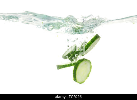 Tranches de concombre frais dans l'eau isolated on white Banque D'Images