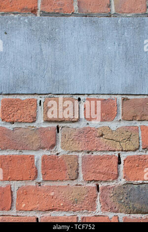 Libre de dirty délavées rouge brun texture mur de briques avec des blocs de béton gris. Banque D'Images