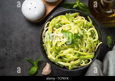 Les pâtes spaghetti à la courgette sur noir vue d'en haut. Banque D'Images