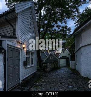 Vue du coucher de soleil d'une rue pavée de la vieille ville de Bergen avec des maisons typiques en bois, Norvège Banque D'Images