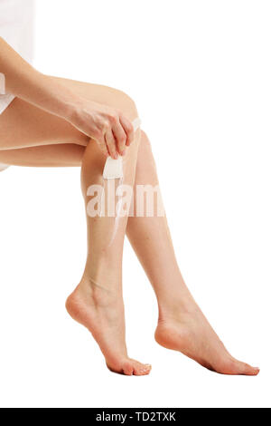 Belle femme avec des jambes L'épilation crème, isolated on white Banque D'Images