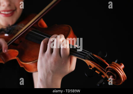 Musicien à jouer du violon sur fond noir Banque D'Images