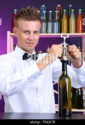 Barman ouvre bouteille de vin Banque D'Images