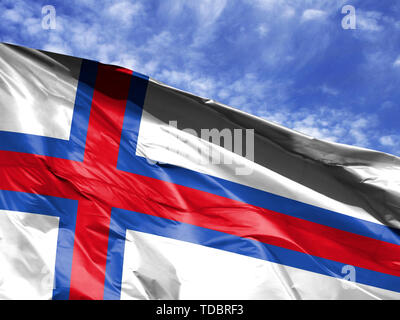 Waving Flag de Îles Féroé close up against blue sky Banque D'Images