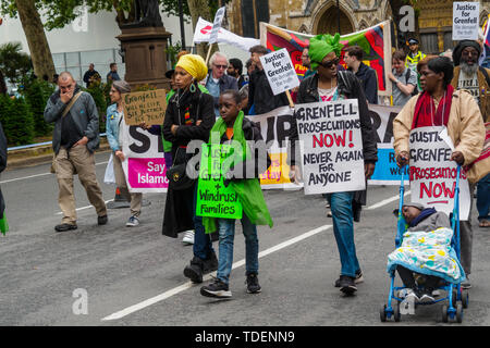 Londres, Royaume-Uni. 15 juin 2019. Les gens de femmes de couleur dans la Grève mondiale des femmes portent des affiches appelant à la justice et des poursuites sur la justice4mars solidarité Grenfell le jour après le deuxième anniversaire de l'incendie dans la tour de Grenfell, dont 72 personnes sont mortes, ainsi que la justice4Grenfell, l'événement a été soutenu par les militants de la sécurité du logement et de la construction et par branches de l'Union des pompiers de partout dans le Royaume-Uni. Peter Marshall/Alamy Live News Banque D'Images