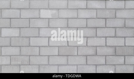 La haute résolution full frame background d'un mur ou d'un extérieur de l'immeuble faite de blocs de béton gris clair. Copier l'espace. Banque D'Images