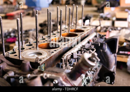 Mécanicien a ouvert la vanne de verrouillage de mécanisme. Démonter le bloc-moteur du véhicule. Ancienne capitale du moteur de réparation. Service de voiture concept. Banque D'Images