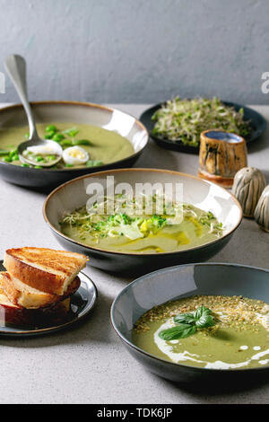 Variété de légumes vert asperges, brocoli, pois et décoré par les verts, légumes, œufs de caille, crème, huile d'olive, de bols de céramique plus de Gray Banque D'Images