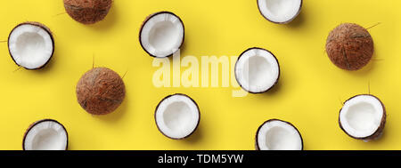 Modèle avec la venue de coco sur fond jaune. Pop art design, creative concept d'été. Bannière. La moitié de la noix de coco dans un minimum de style mise à plat Banque D'Images