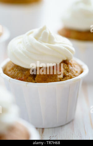 Cupcakes avec glaçage vanille carotte. Table en bois blanc, haute résolution Banque D'Images