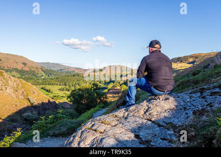 L'homme se détendre et se reposer après une journée de randonnée sur les collines dans le Lake District Banque D'Images