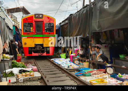 Train roulant à travers Maeklong marché Ferroviaire, Bangkok, Thaïlande Banque D'Images