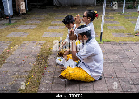Famille balinaise priant le temple pendant un festival religieux Galungan et Kuningan Banque D'Images