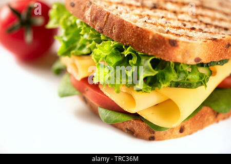 Sandwich avec du fromage et des légumes sur un fond blanc. High key. Banque D'Images
