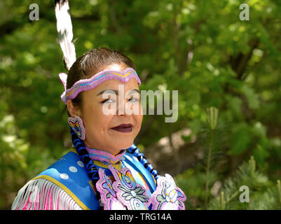 Les Premières Nations Ojibwe femme porte son costume traditionnel et pose pour la caméra au cours de la Barrie Native Friendship Centre Pow Wow 2019. Banque D'Images