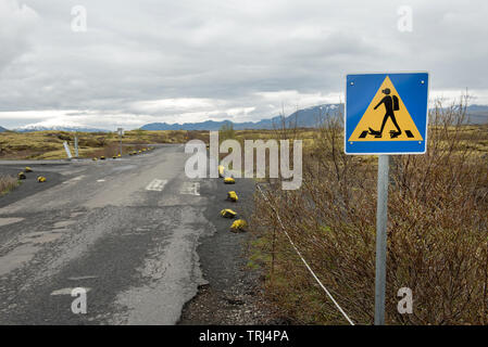 Diver crossing road sign près du lac Thingvallavatn plongée et snorkeling Silfra S.p.a. site en Islande Banque D'Images