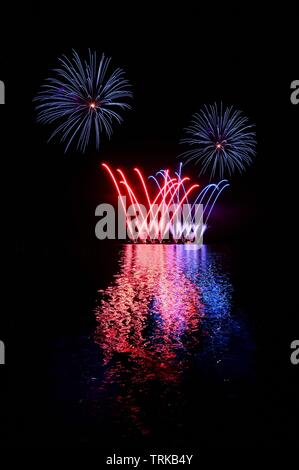 Bel artifice coloré sur la surface de l'eau. Scène de nuit. Concept pour les vacances et les fêtes. Banque D'Images