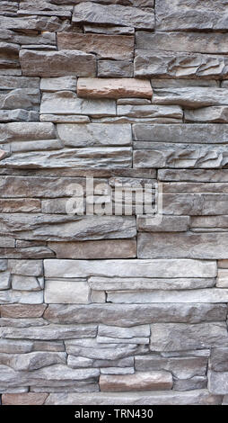 La texture du mur de construire à partir de dalles de pierre et de briques empilées les unes sur les autres. Banque D'Images