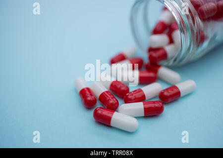 Capsules comprimés médicaments sur fond de couleur bleu Banque D'Images