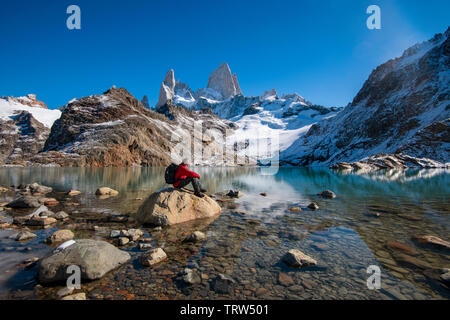 Sat Randonneur admirant la vue sur le Mont Fitz Roy et Cerro Torre avec Lago de los Tres, El Chalten, Patagonie, Argentine. Banque D'Images