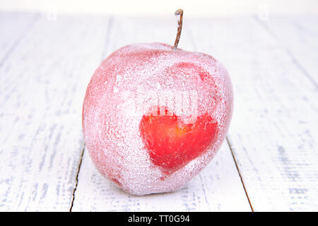 Maison de vacances apple avec un coeur sur fond de bois Banque D'Images