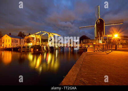 Vue d'un canal avec un petit pont et le moulin de nuit, Leiden, Hollande méridionale, Pays-Bas Banque D'Images