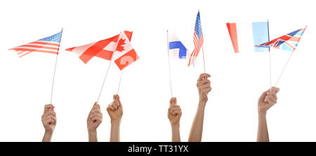 Mains tenant différents drapeaux, isolated on white Banque D'Images