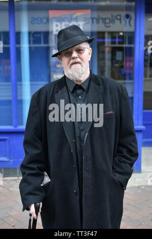 Le centre-ville d'Ashford un homme se tient devant les bureau de Paris dans une veste noire et black hat Banque D'Images