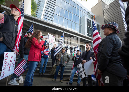 L'Amber Krabach de Bannockburn utilise un mégaphone pour parler à d'autres manifestants contre Rep. Ilhan Omar comme chant counterprotesters à Bellevue, Washington, le samedi 25 mai, 2019. Les Patriotes du groupe de Washington laisse la protestation contre le représentant qui était une garniture de CAIR-WA Ramadan fundraiser. Banque D'Images