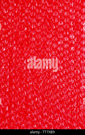 Cellophane et fond en plastique. La texture du plastique d'emballage du vieux avec des ballons. L'image des tons rouge et blanc. Banque D'Images