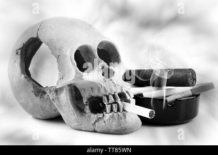 Les fumeurs de cigarettes avec scull dans sa bouche, isolated on white Banque D'Images