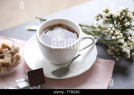 Tasse de café aromatisé avec du chocolat sur la table avec des nappes, gros plan Banque D'Images