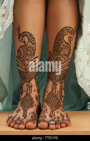 Low section view of an Indian bride legs decorated with mehendi Stock Photo