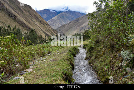 Canaux d'irrigation antiques transportant de l'eau glaciaire des terres agricoles dans la vallée de l'Urubamba. Cusco, Pérou Banque D'Images