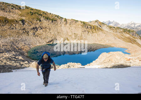 Un alpiniste monte un solo snow patch en route pour Pointe Douglas, en Colombie-Britannique. Banque D'Images