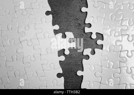 Deux pièces de puzzle blanc sur fond gris Banque D'Images