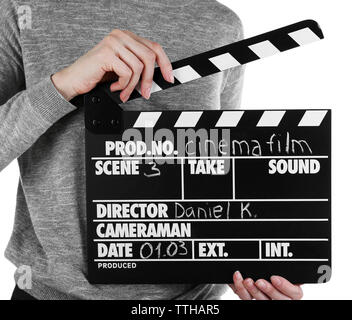 Female hands holding movie clapper isolated on white Banque D'Images