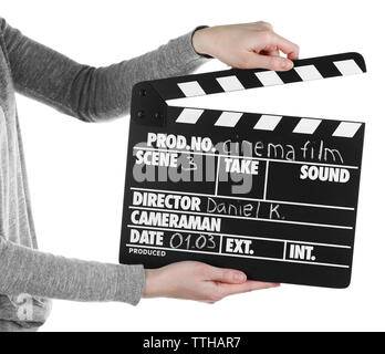 Female hands holding movie clapper isolated on white Banque D'Images