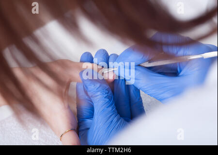 Traitement des ongles de doigt, le meulage et le polissage en instituts de beauté. Processus manucure Banque D'Images