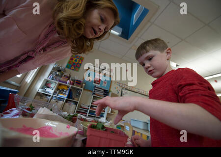 UNITED STATES - DEC. 12, 2016 : Kindergartner Andrew Roos et son professeur Julie Roberts faire des fraises au chocolat pour la Saint-Valentin au cours de c Banque D'Images