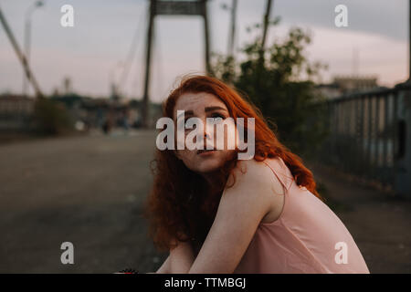 Portrait of teenage girl with freckles assis sur le pont en ville Banque D'Images