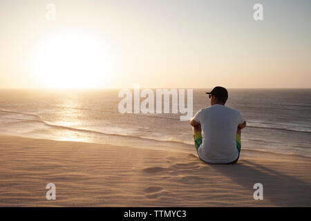 Man sitting on beach Banque D'Images