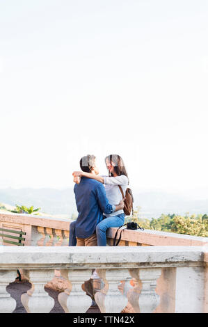 Couple romantique terrasse contre ciel clair Banque D'Images