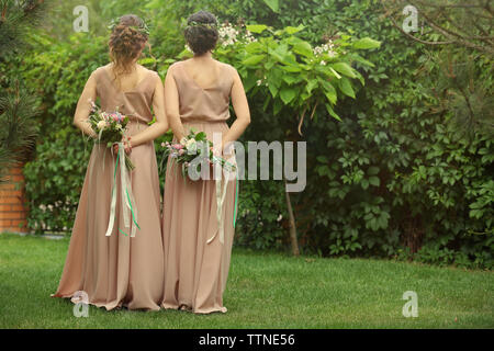 Belles demoiselles holding bouquets Banque D'Images