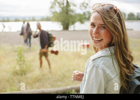 Portrait de femme heureuse avec sac à dos sur terrain Banque D'Images