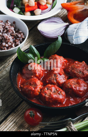 Boulettes de pois chiches vegan et le riz brun dans la poêle en fonte sur table en bois rustique, Close up, selective focus, aliments à base de plantes Banque D'Images