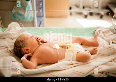 High angle view of newborn baby girl sleeping in hospital