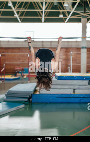 L'exercice de gymnaste sur kip at gym Banque D'Images